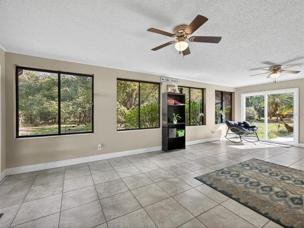 11321 Scenic View Lane Orlando, FL 32821 - Photo 17 of 29 a view of livingroom with furniture ceiling fan and window