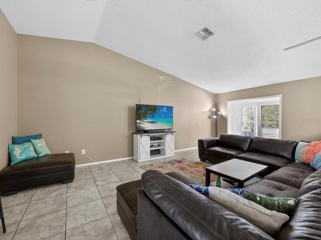 11321 Scenic View Lane Orlando, FL 32821 - Photo 5 of 29 a living room with furniture and a flat screen tv