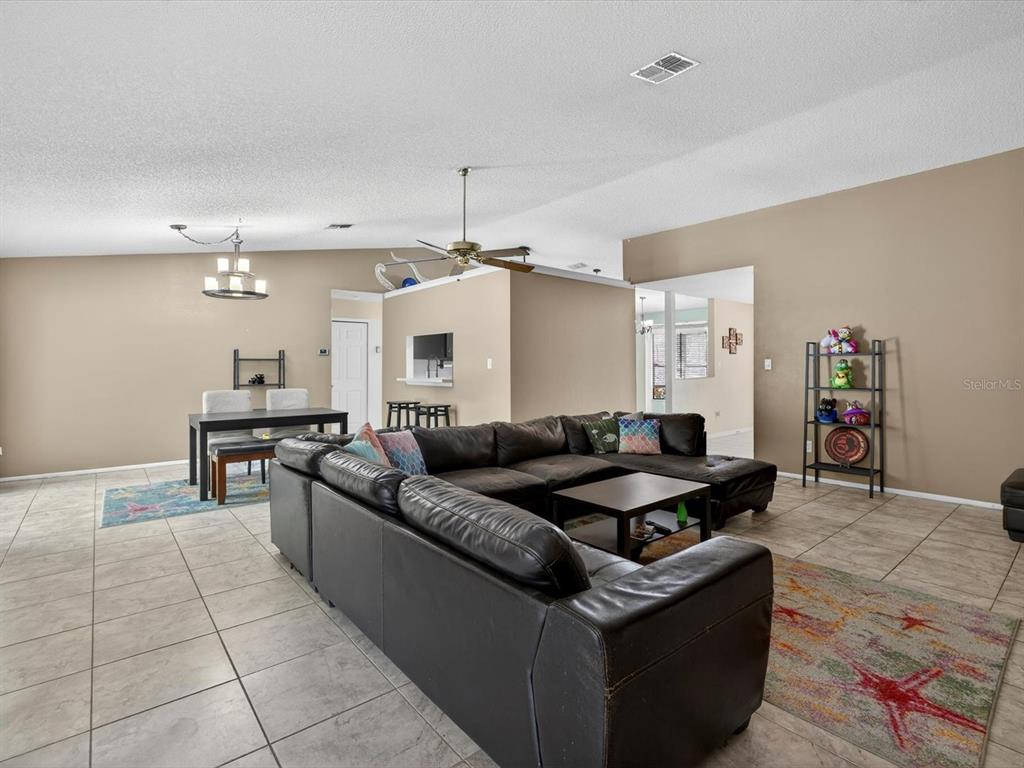 11321 Scenic View Lane Orlando, FL 32821 - Photo 6 of 29 a living room with granite countertop furniture and kitchen view