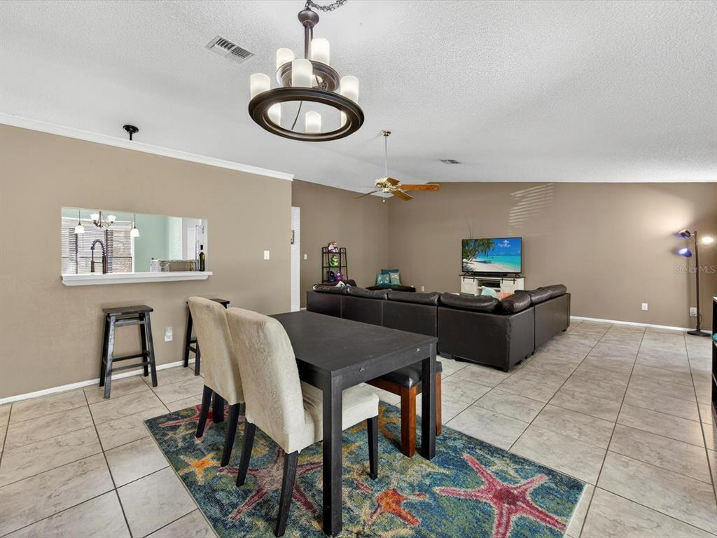 11321 Scenic View Lane Orlando, FL 32821 - Photo 7 of 29 a living room with furniture and a chandelier