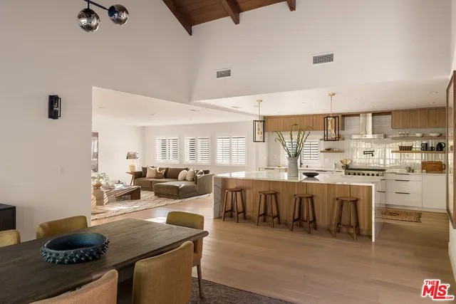 a view of a wooden chairs and table in the backyard