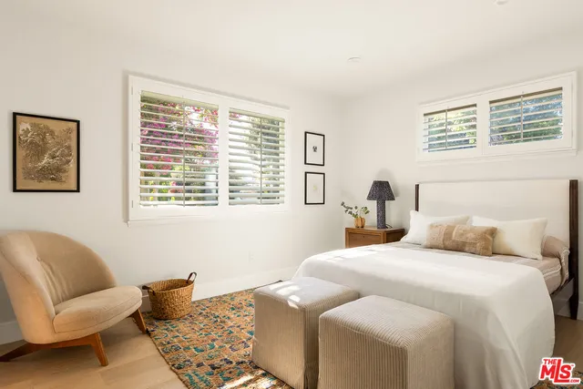 a bedroom with a bed and a chair