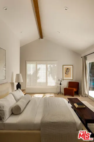 a bedroom with a bed and a couch