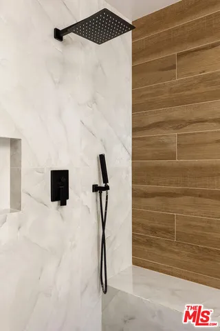 a bathroom with a double vanity sink a mirror and a shower