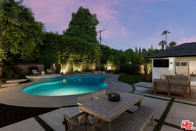 a view of swimming pool with outdoor seating