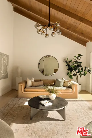 a view of a dining room with furniture wooden floor and chandelier