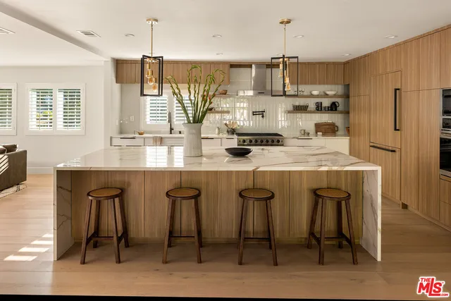 a living room with furniture a chandelier and a table