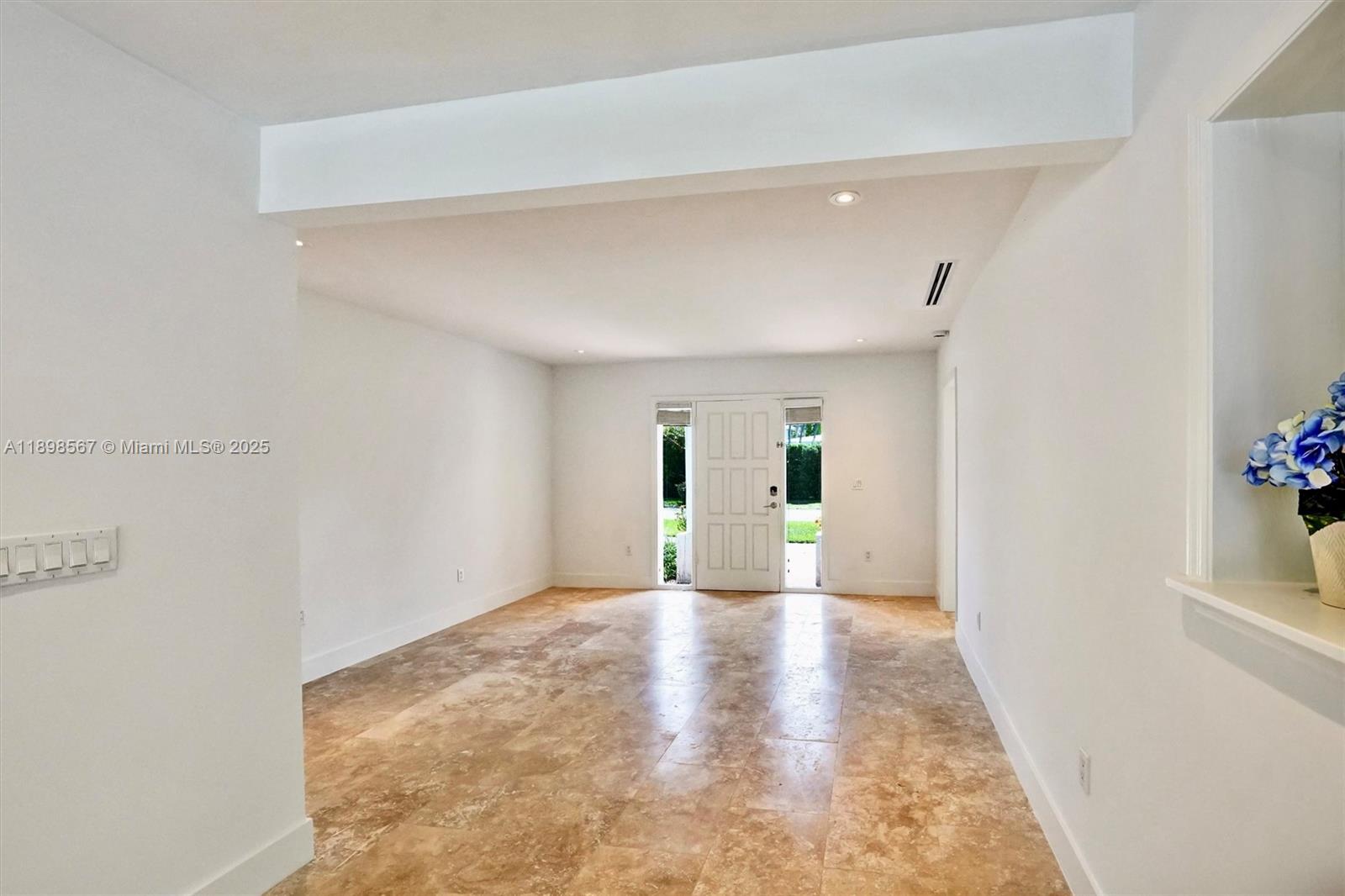 255 Ridgewood Road Key Biscayne, FL 33149 - Photo 17 of 55 a view of a hallway with wooden floor and a living room