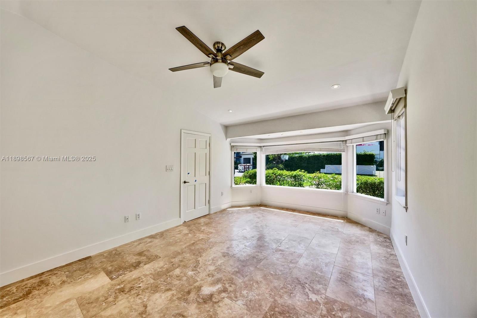 255 Ridgewood Road Key Biscayne, FL 33149 - Photo 20 of 55 a view of room with window and a ceiling fan