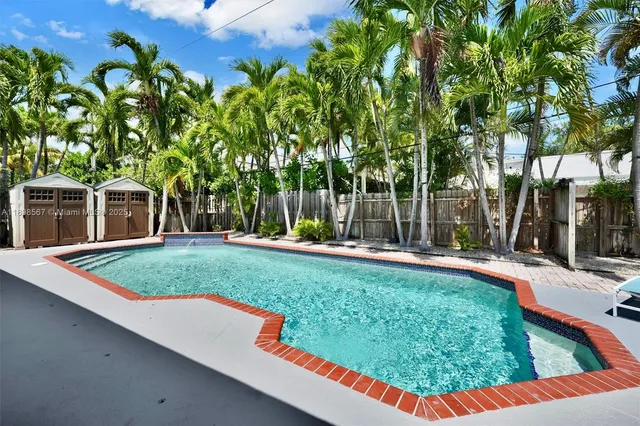 a view of a backyard with swimming pool