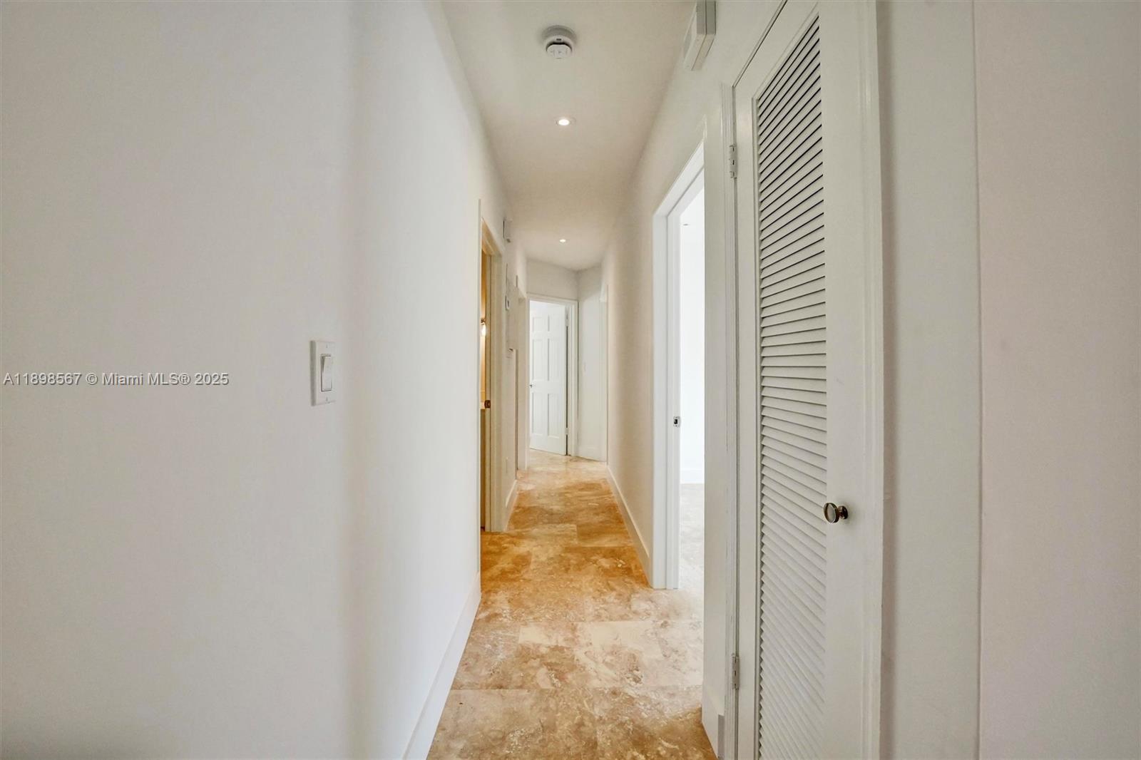 255 Ridgewood Road Key Biscayne, FL 33149 - Photo 25 of 55 a view of a hallway with wooden floor and staircase