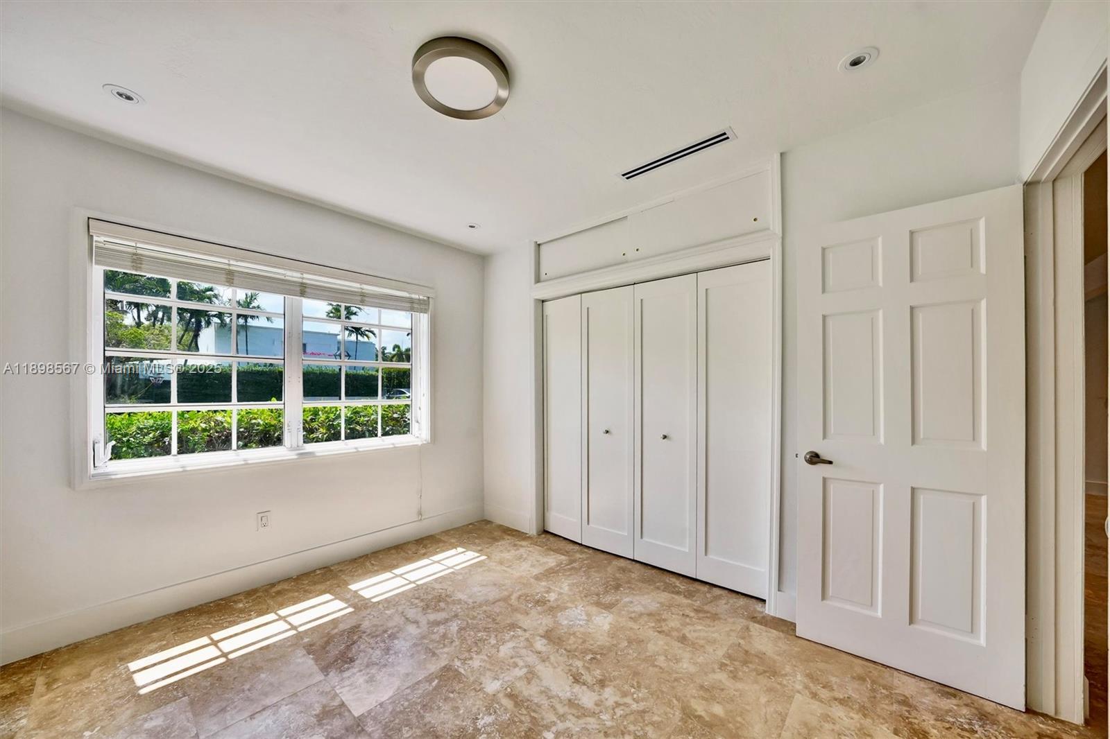 255 Ridgewood Road Key Biscayne, FL 33149 - Photo 26 of 55 a view of an empty room with a window