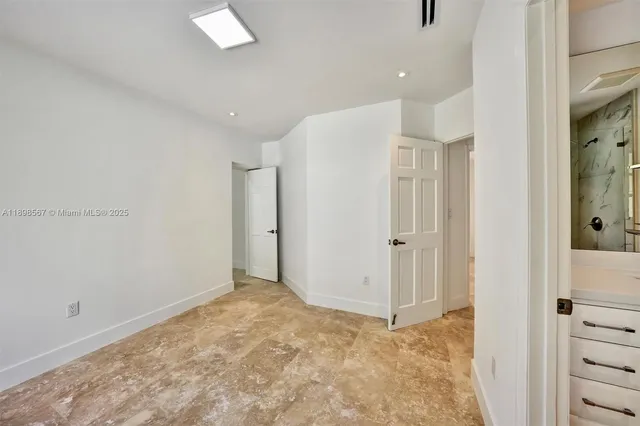 a bathroom with a sink a toilet and a large mirror