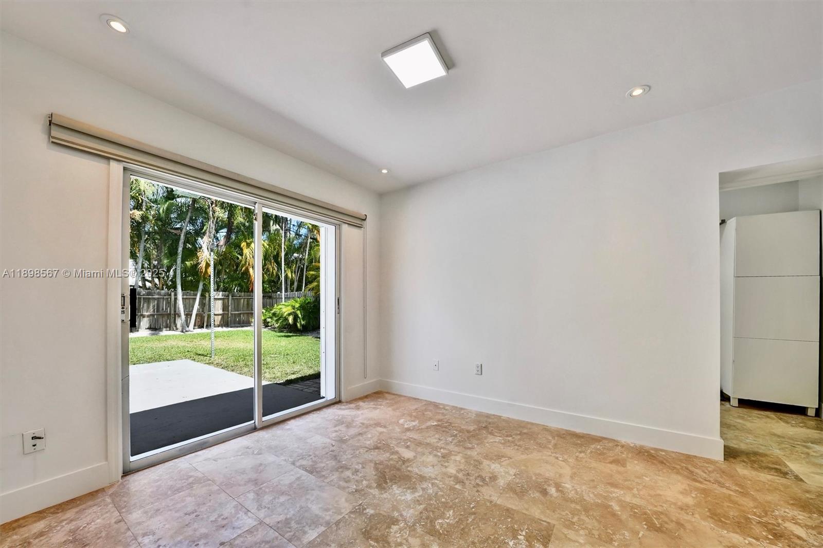 255 Ridgewood Road Key Biscayne, FL 33149 - Photo 33 of 55 a view of an empty room with wooden floor and a window