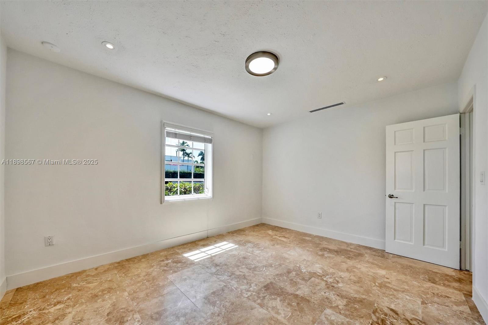 255 Ridgewood Road Key Biscayne, FL 33149 - Photo 35 of 55 a view of an empty room with a window