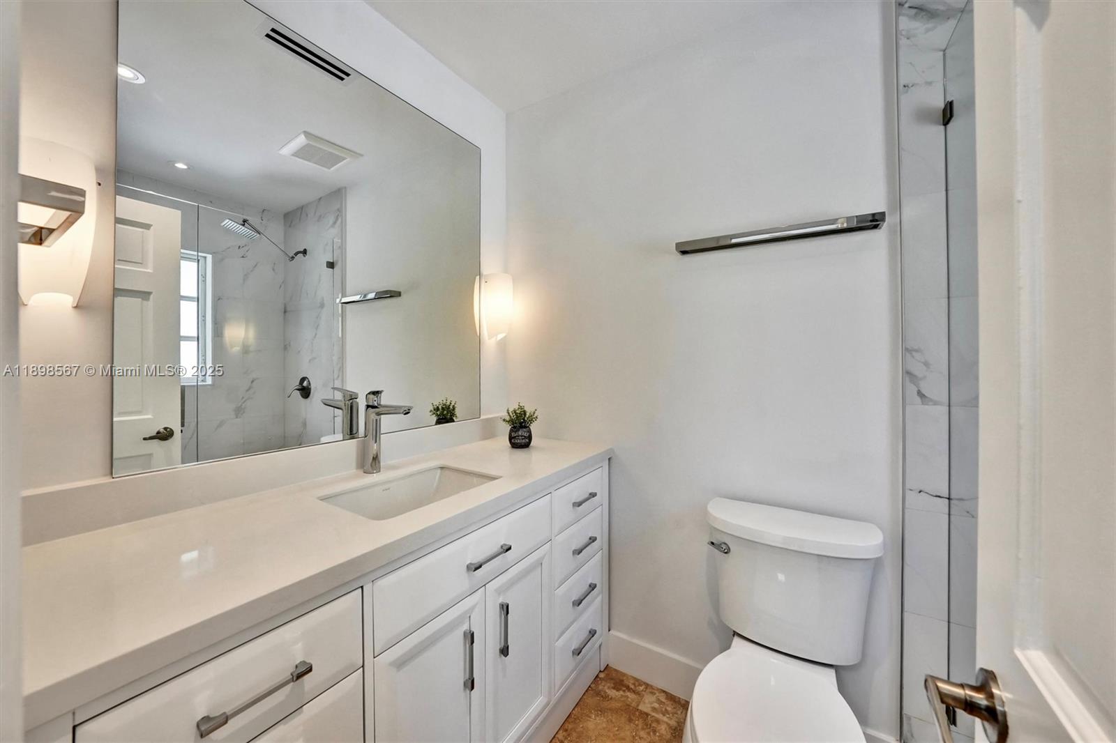 255 Ridgewood Road Key Biscayne, FL 33149 - Photo 36 of 55 a bathroom with a sink a toilet and a large mirror