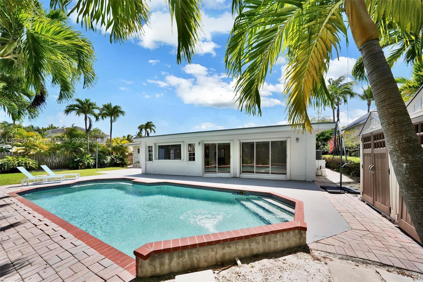 255 Ridgewood Road Key Biscayne, FL 33149 - Photo 45 of 55 a view of a house with a swimming pool