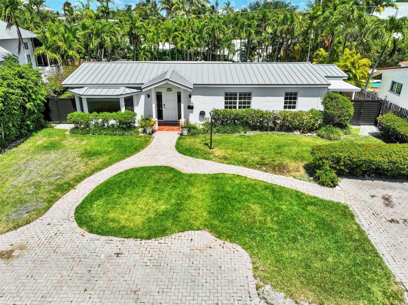 255 Ridgewood Road Key Biscayne, FL 33149 - Photo 6 of 55 a view of a house with a garden and plants