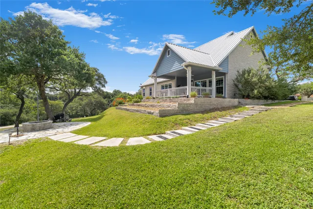 a front view of a house with a yard table and chairs
