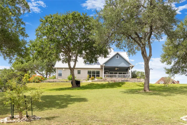 a front view of a house with swimming pool having outdoor seating
