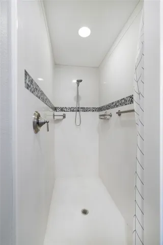 a bathroom with a granite countertop sink mirror and toilet