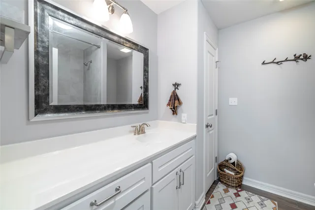a bathroom with a tub sink and mirror