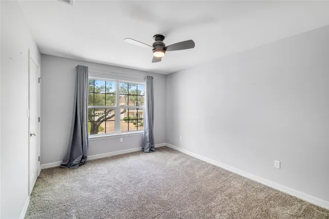 a view of a balcony with floor to ceiling window and wooden floor