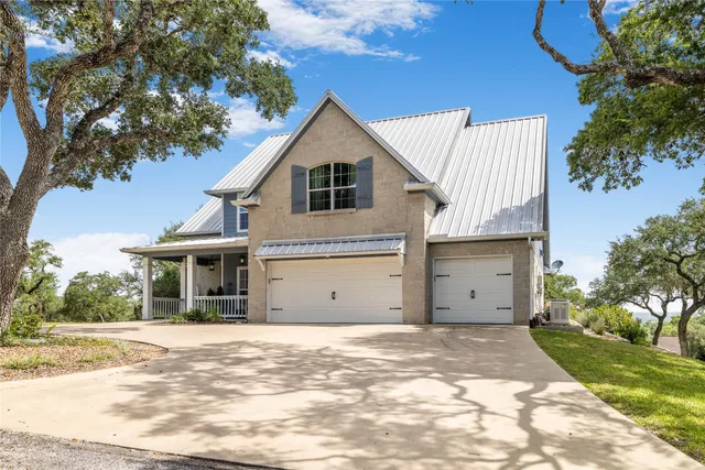 a view of house with swimming pool and a yard