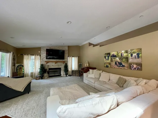 a living room with furniture and a fireplace