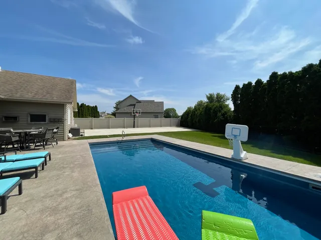 a view of swimming pool with seating space