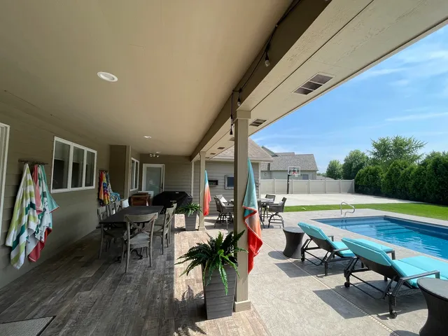 a living room with furniture pool table and rug