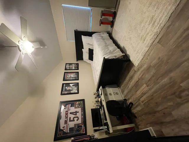 a bedroom with a bed and a chandelier