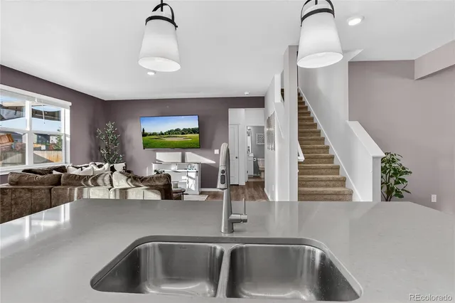 a kitchen with a sink and a refrigerator