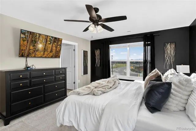 a bedroom with a bed and a flat tv screen