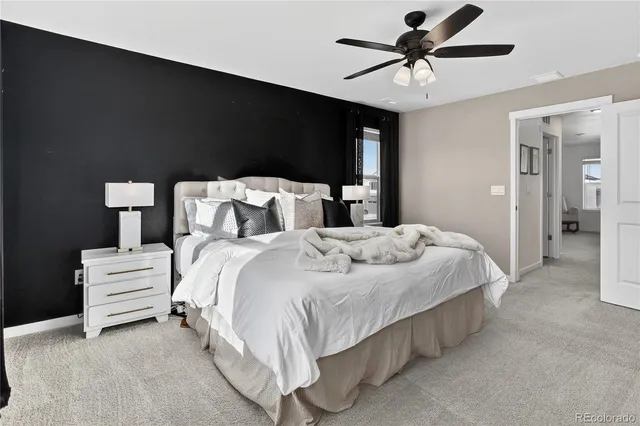 a bedroom with bed and a chandelier