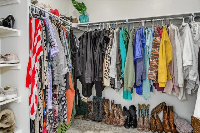 a view of walk in closet with clothes