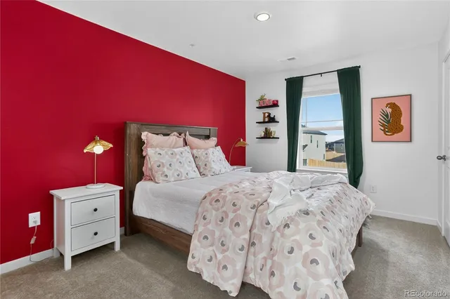 a bedroom with a bed and lamp