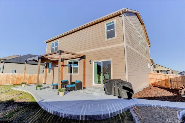 a view of a house with backyard and sitting area