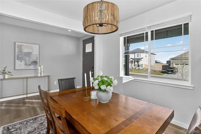 a view of a dining room with furniture and a chandelier