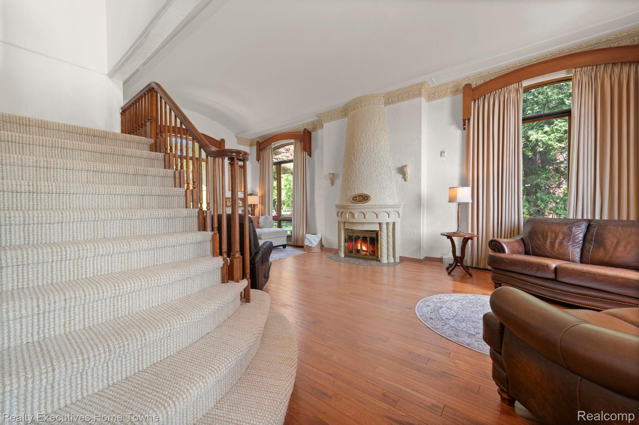 8308 Lakeshore Road Fort Gratiot, MI 48059 - Photo 44 of 79 Grand staircase featuring wood banister and carpeted treads