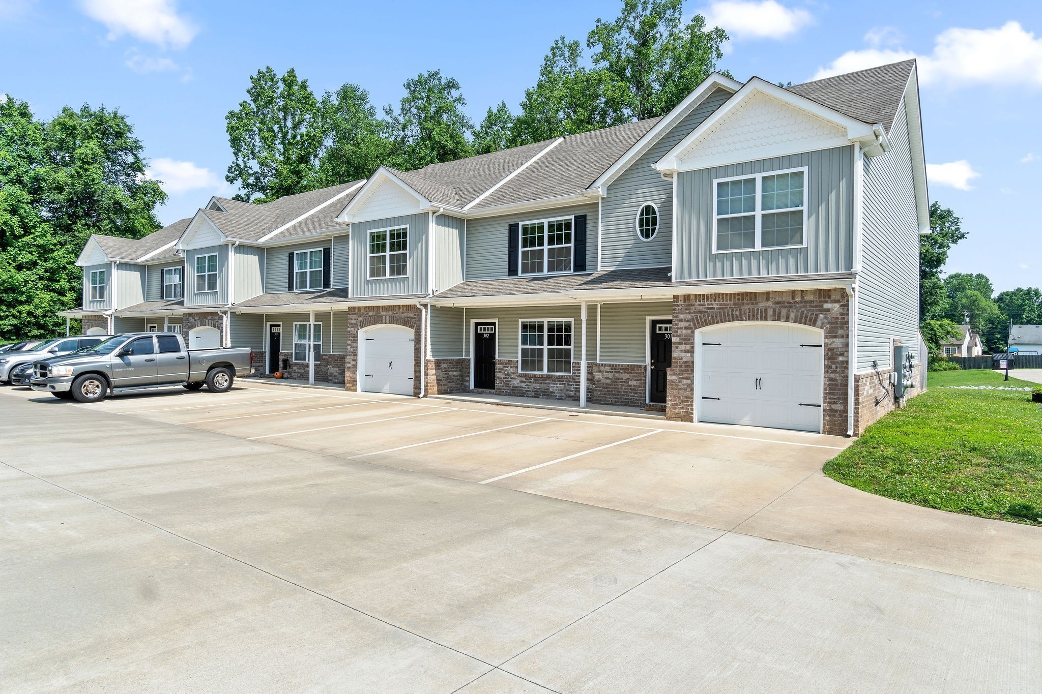 1552 Tylertown Road, Unit 104 Clarksville, TN 37040 - Photo 1 of 21 a front view of a house with a yard and garage