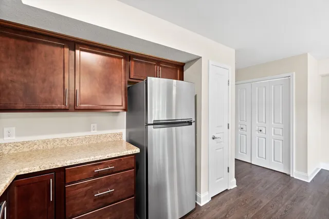 a kitchen with a refrigerator and cabinets
