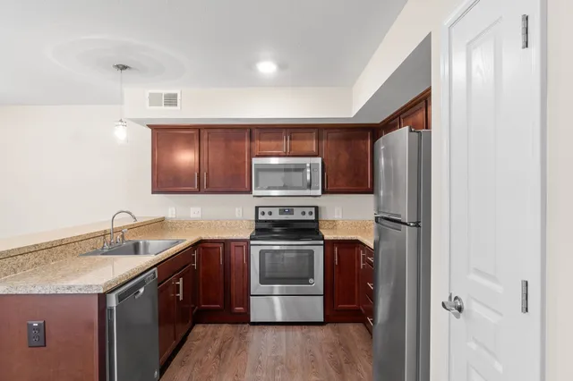 a kitchen with a sink stove and refrigerator