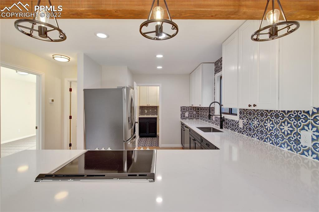 9 Sutherland Road Manitou Springs, CO 80829 - Photo 11 of 31 a kitchen with stainless steel appliances granite countertop a refrigerator a sink and a stove