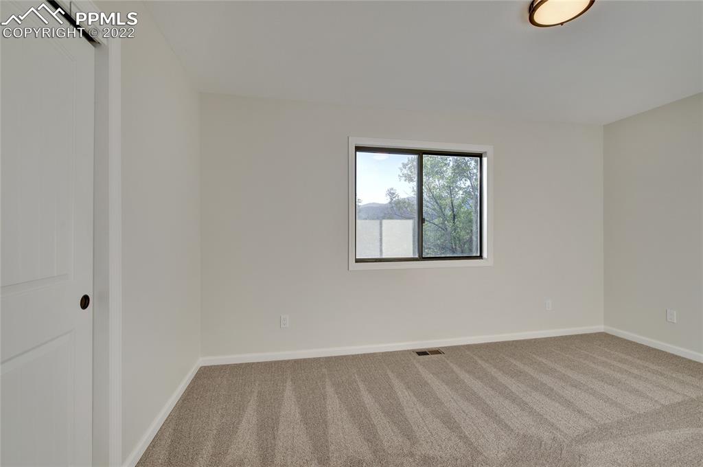 9 Sutherland Road Manitou Springs, CO 80829 - Photo 16 of 31 a view of an empty room with wooden floor and a window