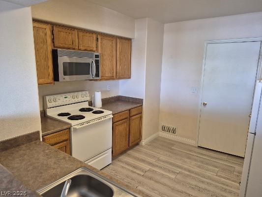 7255 West Sunset Road, Unit 2164 Las Vegas, NV 89113 - Photo 9 of 16 Natural wood cabinetry and neutral solid-surface countertops define this functional culinary space.