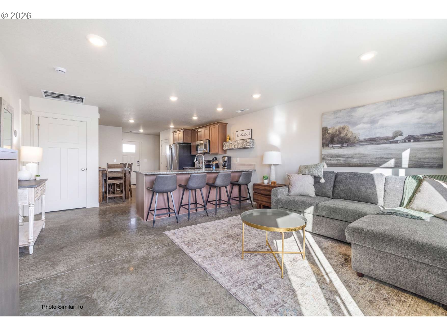 1104 Northeast 11th Street Hermiston, OR 97838 - Photo 2 of 19 a living room with furniture and a dining table with kitchen view