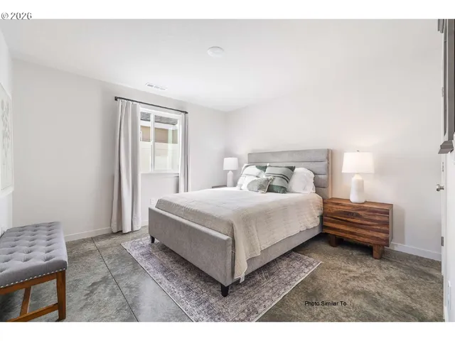 a bedroom with a bed and a night stand