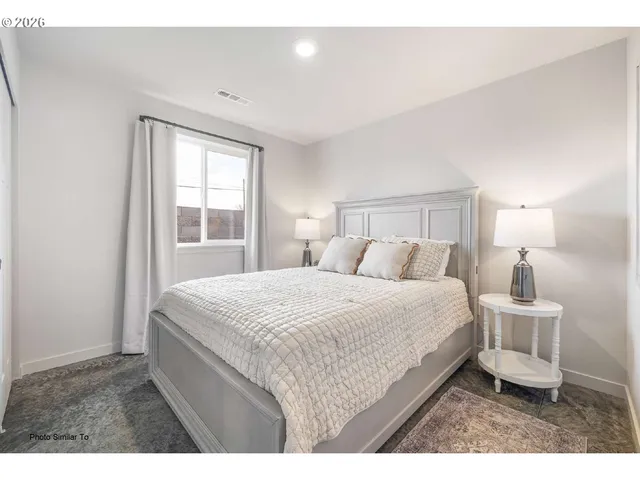 a bedroom with a bed a window and walk in closet