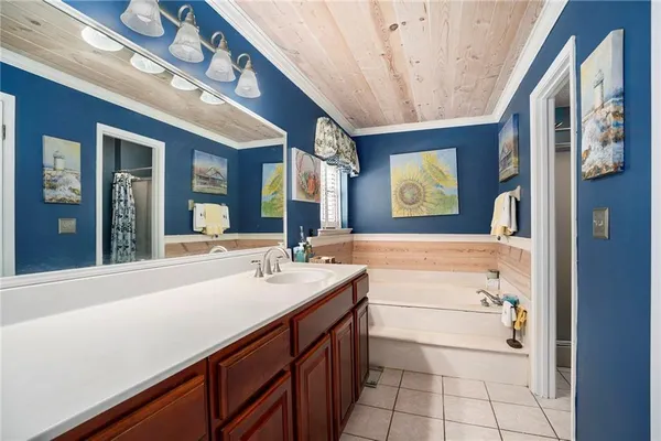 a bathroom with a sink a large mirror and a bathtub